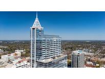Stunning aerial view of a high-rise building with modern architecture and a clear blue sky backdrop at 301 Fayetteville St # 3205, Raleigh, NC 27601