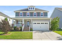 Charming two-story home featuring a covered porch, two car garage, and well-maintained lawn at 4508 Brintons Cottage St, Raleigh, NC 27616