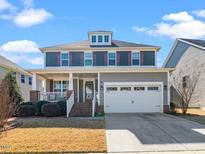 Charming two-story home with a covered front porch, two-car garage and beautifully landscaped yard at 4508 Brintons Cottage St, Raleigh, NC 27616