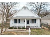 Charming home featuring a well-maintained front yard, classic white siding, and a welcoming front porch with decorative railings at 847 Estes St, Durham, NC 27701