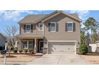 Charming two-story home with a two-car garage, stone accents, and well-maintained landscaping at 1008 Scotch Pine Way, Mebane, NC 27302