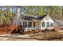 Charming single-story home featuring green shutters and a welcoming yellow wreath on the front door at 1109 Sorcerer Ct Ct, Knightdale, NC 27545