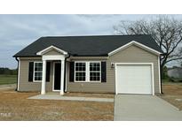 Charming single-story home featuring a covered entry, black shutters, and an attached one-car garage at 114 Johnson Ridge Way, Four Oaks, NC 27524