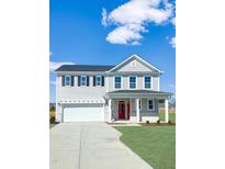 Charming two-story home featuring a red front door, gray siding, and an attached two-car garage at 120 Whistling Way # Cary Traditiol, Lillington, NC 27546