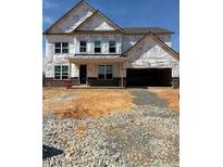New construction home showing the front of a two-story house with a two-car garage and unfinished landscaping at 1208 Opal Ln # 92, Durham, NC 27705