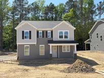 New two-story home featuring gray siding, black shutters, and a welcoming front porch at 1803 Ballard Rd # Holly Craftsman, Fuquay Varina, NC 27526