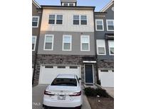 Charming townhome exterior with brick accents and a well-maintained front yard at 1833 Fahey Dr, Apex, NC 27502