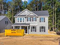Two-story home featuring gray brick, siding, black shutters, and a covered front porch at 1849 Ballard Rd # Holly Georgian, Fuquay Varina, NC 27526
