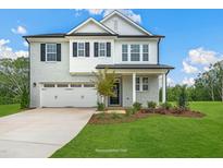 Charming two-story home features a light-brick facade, black shutters, and a well-manicured lawn at 1849 Ballard Rd # Holly Georgian, Fuquay Varina, NC 27526