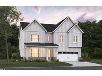 Inviting two-story home featuring white siding, black roof, brick foundation, and an attached two-car garage at 2004 Skipping Stone Dr # 165, Durham, NC 27705