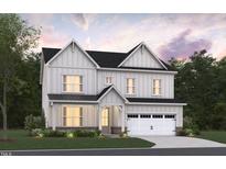 Charming two-story home with a manicured lawn, a two-car garage, and a welcoming covered front porch at 2020 Skipping Stone Dr # 161, Durham, NC 27705