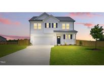 Charming two-story white home with a well-manicured lawn and a long driveway leading to a two-car garage at 22 Whistling Way # 18, Lillington, NC 27546