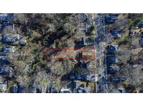Aerial view of property highlighting its generous lot size, mature trees, and location within a residential area at 306 N Driver St, Durham, NC 27703