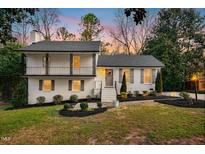 Charming two-story home with landscaped yard and front door wreath at 5613 Ashton Dr, Raleigh, NC 27612