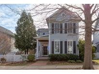 Charming two-story home with gray siding, black shutters, and a welcoming front porch at 705 Highgrove Dr, Chapel Hill, NC 27516