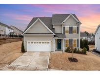 Charming two-story home featuring neutral siding, gray shutters, and a well-manicured front yard at 708 Pitchback Mill Ct Ct, Wake Forest, NC 27587