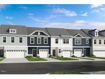 Charming new townhomes feature varied facades, attached garages, and manicured landscaping at 8711 Wardle Ct, Wake Forest, NC 27587