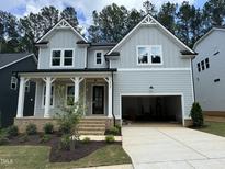Beautiful two-story home with a welcoming front porch and an attached garage at 122 Sanderway Dr, Chapel Hill, NC 27516