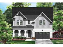 Charming two-story home with a mix of white and gray vertical siding at 122 Sanderway Dr, Chapel Hill, NC 27516