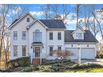 Charming two-story home with a manicured front yard and attached two-car garage at 14 Wedgewood Pl, Clayton, NC 27527