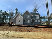 Beautiful two-story home featuring a modern design, gray siding, and architectural roofline at 1433 Starry Night Ct, Raleigh, NC 27613
