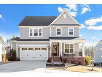 Charming two-story home featuring a welcoming front porch and attached two-car garage at 169 Hidden Bluff Dr, Chapel Hill, NC 27517