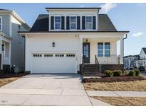 Charming two-story home with white siding, black shutters, and an attached two-car garage at 1800 Bright Lantern Way, Wendell, NC 27591