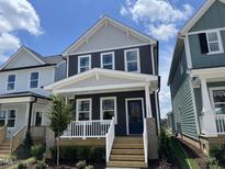 Charming two-story home features a welcoming front porch and a modern blue door at 1903 Plott Balsam Dr, Wendell, NC 27591
