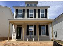 Charming two-story home with a covered front porch and black shutters at 320 White Oak Garden Way # 218, Garner, NC 27529