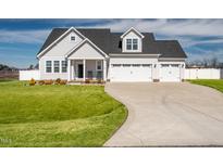 Beautiful two-story home with a three-car garage and manicured front lawn at 40 Thunder Valley Ct, Lillington, NC 27546