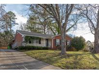 Charming brick home with a well-maintained front yard and mature trees at 513 Princeton St, Raleigh, NC 27609