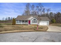 Charming single-story home with light gray siding, well-manicured lawn, and inviting front porch at 59 Tristan Dr, Kenly, NC 27542