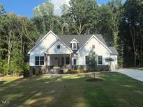 New construction home featuring white siding, dark trim, and a well-manicured lawn at 60 Valebrook Ct, Youngsville, NC 27596