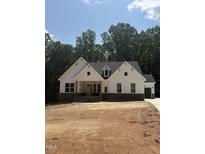 New construction home with white siding, stone accents, and a well-lit front porch at 60 Valebrook Ct, Youngsville, NC 27596