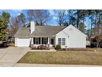Charming single-story home with white siding, well-maintained lawn, and attached garage at 613 Flaherty Ave, Wake Forest, NC 27587