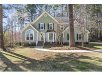 Charming two-story home featuring traditional architecture, a manicured lawn, and a welcoming front entrance at 8063 Hogan Dr, Wake Forest, NC 27587