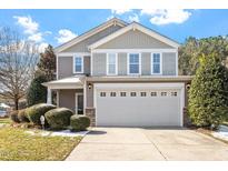 Two-story home showcasing a front-facing two-car garage and beautifully landscaped front yard at 904 Churchill Glen Blvd, Knightdale, NC 27545