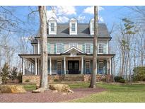 Charming two-story home with stone accents, inviting front porch, and well-manicured lawn at 907 Vintage Hill Pkwy, Durham, NC 27712