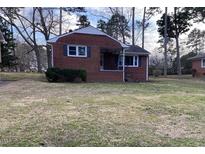 Charming brick home featuring a cozy front porch and well-maintained lawn at 103 W Thorndale Dr, Oxford, NC 27565