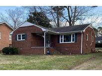 Charming brick home with black shutters and a well-maintained lawn at 103 W Thorndale Dr, Oxford, NC 27565