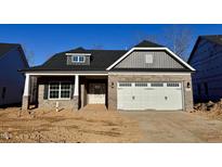 New construction features a brick facade, a two-car garage, and a contrasting gray gable at 1067 Fairhaven Dr # 53, Mebane, NC 27302