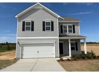 Charming two-story home with a two-car garage, black shutters, and a well-manicured lawn at 111 E Victory View Ter, Smithfield, NC 27577