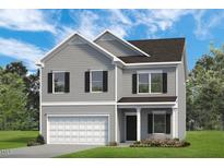 Charming two-story home featuring gray siding, black shutters, and an attached garage at 111 E Victory View Ter, Smithfield, NC 27577