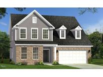 Charming two-story home featuring a mix of gray siding and stone accents, complemented by dormer windows and a two-car garage at 124 Willow Cameron Way, Angier, NC 27501