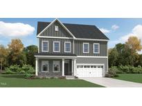 Charming two-story home with a covered porch and attached two-car garage, complemented by a beautifully landscaped front yard at 1308 Hazelnut Ridge Ln, Knightdale, NC 27545