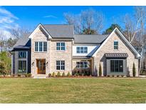 Beautiful two-story brick home with a manicured lawn and a classic architectural design at 149 Bonica Creek Dr, Garner, NC 27529
