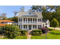 Charming two-story home featuring a welcoming front porch and landscaped front yard, with classic black window shutters at 1530 The Preserve Trail, Chapel Hill, NC 27517