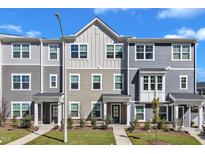 Attractive townhomes feature varied siding, well-manicured lawns and sidewalks for community charm at 1723 Starlit Sky Ln, Cary, NC 27519