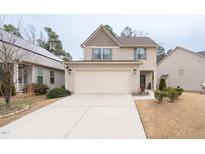 Charming two-story home featuring a two-car garage, neutral siding, and well-maintained landscaping at 207 Kinnakeet Dr, Durham, NC 27704
