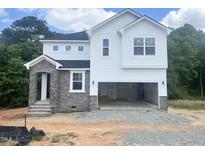 New two-story home with stone accents, white siding, and an attached two-car garage at 212 Fast Pitch Ln, Four Oaks, NC 27524